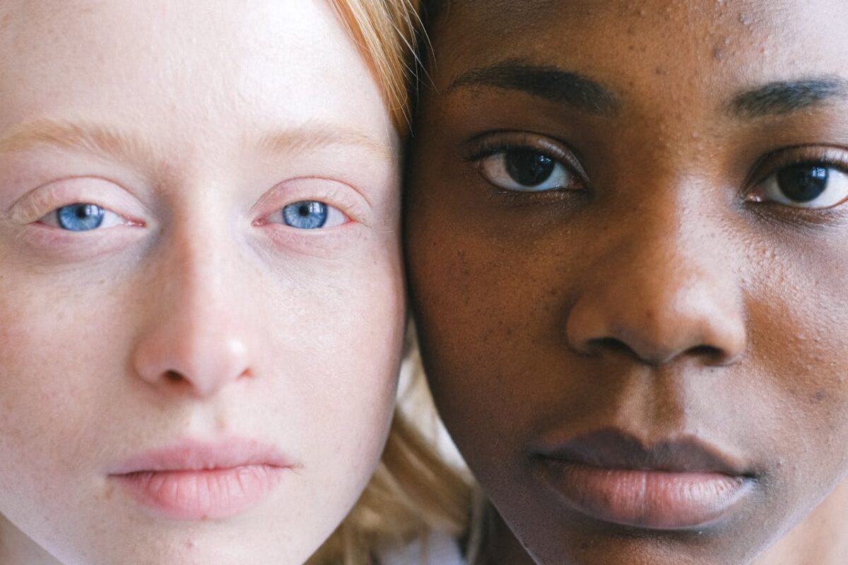 A close-up portrait highlighting diverse facial features and expressions of two women.